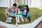 Parent and son gardening activity outdoor in the garden house