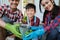 Parent and son showing plant while gardening at home.