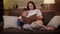 Parent teaches child to read before school, distance learning, concept child development. Caring pregnant mother reads