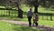 Parent teaching a child to how to ride bicycle without stabilisers in the park