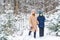 Parenting, fun and season concept - Happy mother and son having fun and playing with snow in winter forest