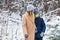 Parenting, fun and season concept - Happy mother and son having fun and playing with snow in winter forest