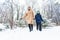 Parenting, fun and season concept - Happy mother and son having fun and playing with snow in winter forest