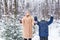 Parenting, fun and season concept - Happy mother and son having fun and playing with snow in winter forest