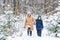 Parenting, fun and season concept - Happy mother and son having fun and playing with snow in winter forest