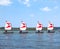 PARENTIS-EN-BORN, FRANCE - JULY 25, 2018: Four dinghy with a red-white sails on the lake. Sailboats go in a dense state