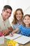 Parents assisting girl in drawing