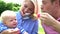 Parents Blowing Bubbles For Young Boy In Garden