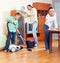 Parents and boy cleaning in room