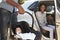 Parents Bringing Newborn Baby Home In Car