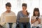 Parents and child daughter using laptops and smartphone at home