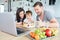 Parents and child eat cake while video chat