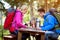 Parents and child look map in the forest