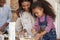 Parents And Children Baking Cakes In Kitchen Together