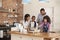 Parents And Children Baking Cakes In Kitchen Together