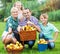 Parents and children with baskets apples