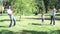 Parents and children having fun playing baseball in a park