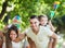 Parents with children playing colorful windmills