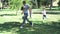 Parents and children playing in a park with a ball