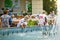 Parents with children splashing in the fountain.