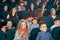 Parents and children watching film in cinema and entertaining.