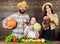 Parents and daughter celebrate harvest holiday pumpkin vegetables fruits. Family rustic style farmers market with fall