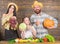 Parents and daughter celebrate harvest holiday pumpkin vegetables fruits. Family rustic style farmers market with fall