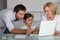 Parents and daughter on laptop