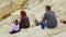 Parents and daughter sitting on ancient amphitheater seats, family travel