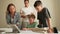 Parents doing homework with kids. Father and mother, and brother helping son do homework