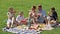 Parents with four kids enjoying watermelon