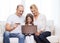 Parents and girl with laptop and credit card