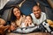 Parents, girl and portrait in tent at house with toys, games and smile with bonding, love and playing together. Mother