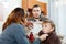 Parents giving medicinal sirup to boy