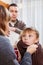 Parents giving medicinal sirup to teenager