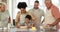 Parents, grandparents and kids with a blended family baking food in a kitchen of their home together during a visit