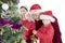 Parents helping sons to decorate a Christmas tree