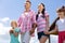 Parents holding their hands while walking with children