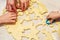 Parents and kids cook sweet cookies in the kitchen together