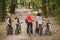 Parents and kids cycling on forest trail. family in warm clothes cycling autumn park. Family mountain bike on forest. active