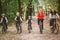 Parents and kids cycling on forest trail. family in warm clothes cycling autumn park. Family mountain bike on forest. active