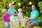 Parents with kids having lunch outdoors