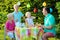 Parents with kids having lunch outdoors