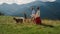 Parents kids walking dog on mountain hill. Girl with mother holding husky leash.