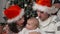 Parents kiss the cheeks of a little baby, Christmas