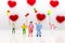 Parents love each other happily, with children playing balloons are behind, used as a wedding anniversary concept