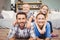 Parents lying on floor while children sitting on their back