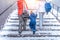 Parents mom and girlfriend girl hold hand little boy son 3-6 years old, go up stairs in transition, winter city backdrop