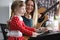 Parents play guitars, daughter on synthesizer