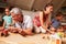 Parents playing with kids and toys in an attic playroom